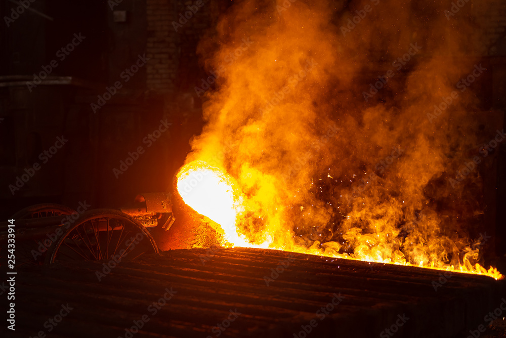 Very hot metal casting in a old steel factory Very hot metal casting in a old steel factory
