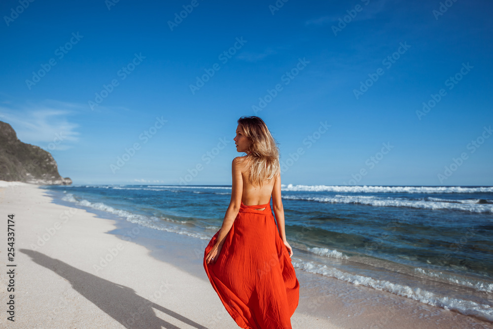 Girl walking on the white sand on the beach. Girl walking on the white sand on the beach.