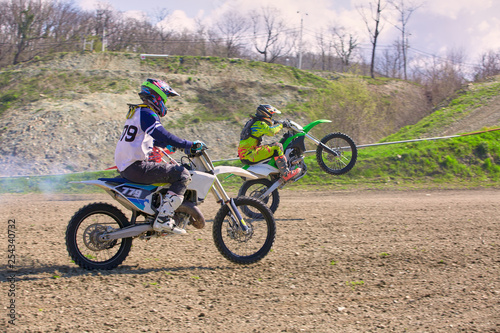 competition between two motocross bikes, side view
