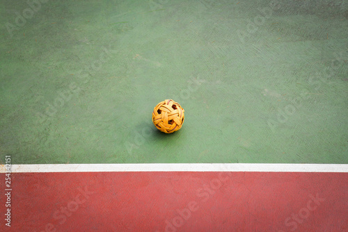 Sepak Takraw ball or rattan ball on field of sepak takraw court with line on sport outdoors photo