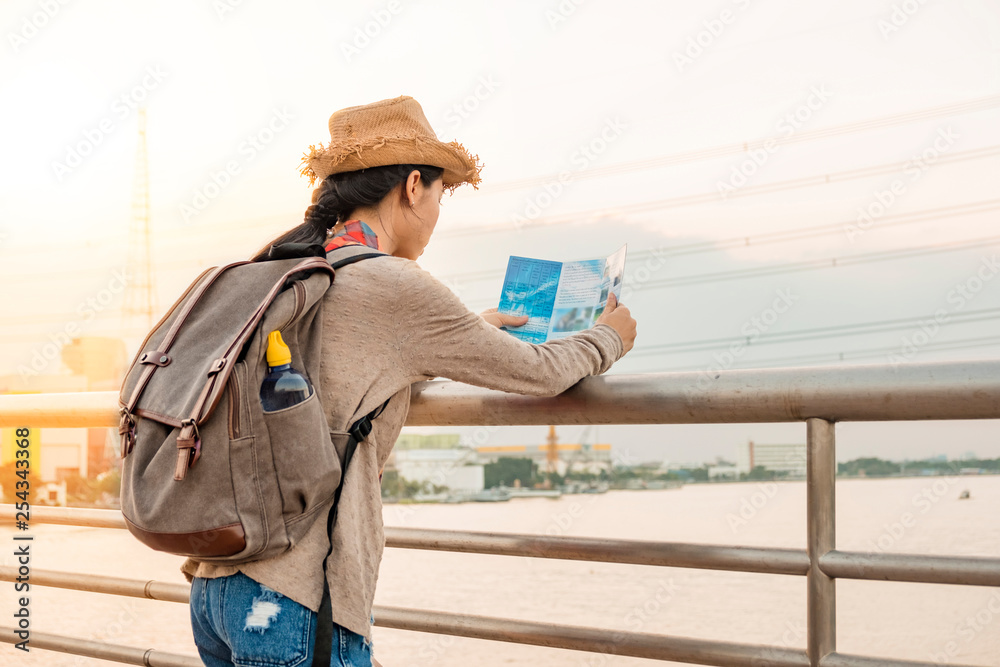 Asian girl tourist backpack Have a map to find places to visit. See directions to go next in the holiday. Asian girl tourist backpack Have a map to find places to visit. See directions to go next in the holiday.