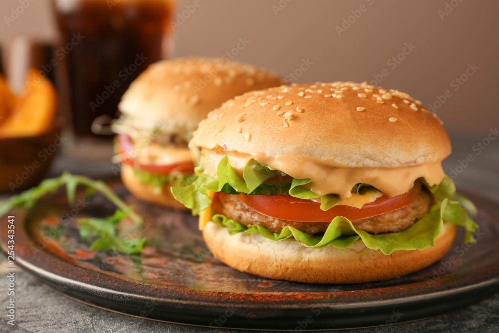 Plate with tasty burgers on table, closeup Plate with tasty burgers on table, closeup