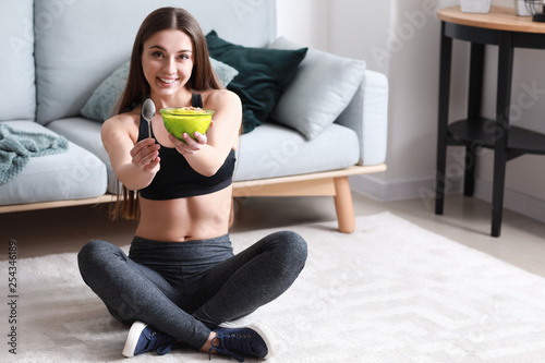 Sporty woman eating tasty y...