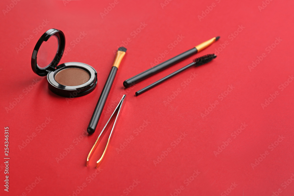 Set of tools for eyebrows correction and eyeshadows on color background Set of tools for eyebrows correction and eyeshadows on color background
