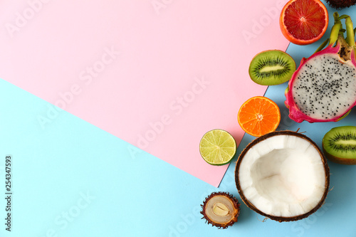 Assortment of tasty exotic fruits on color background