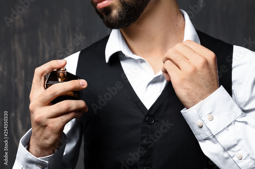 Handsome man with bottle of...