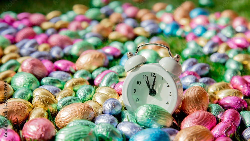 color Chocolate Easter eggs and alarm clock