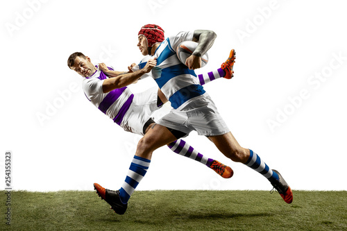 Fototapeta Naklejka Na Ścianę i Meble -  The silhouette of two caucasian rugby male players isolated on white background. Studio shot of fit men in motion or movement with ball. Jump and action concept. An incredible strain of all forces.