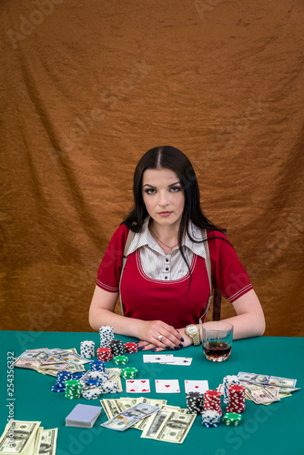 Woman sitting behind poker table in casino