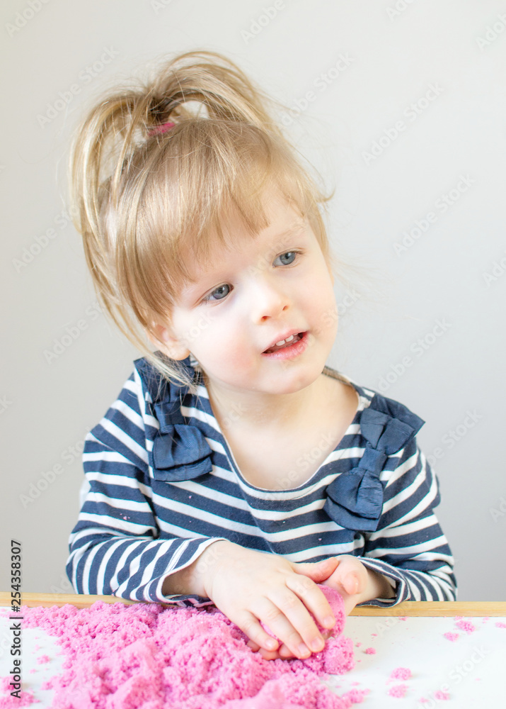 Little Happy Caucasian Girl Playing with Pink Kinetic Sand at Home Early Education Preparing for School Development Children Game Little Happy Caucasian Girl Playing with Pink Kinetic Sand at Home Early Education Preparing for School Development Children Game