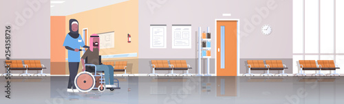 disabled arab man patient in wheelchair with african arabic nurse walking in hospital corridor hall modern clinic interior female male cartoon characters full length flat horizontal