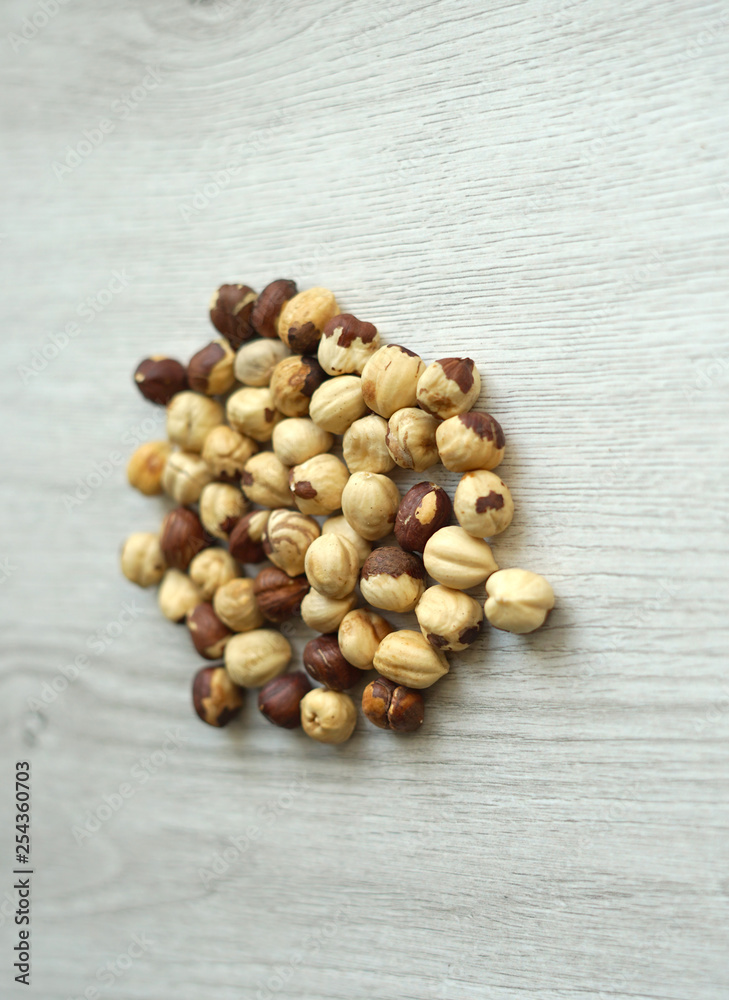 Healthy food for background image close up hazelnuts. Nuts texture on white grey table top view Healthy food for background image close up hazelnuts. Nuts texture on white grey table top view