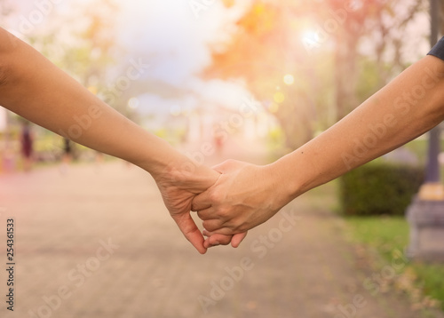 Woman and man holding Shake hands, Happy couple love in the garden.