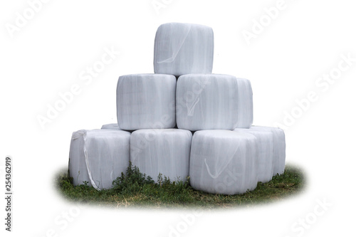 Stacked like a pyramid,bales of silage , wrapped in a membrane. Food  for the cows in the winter on a dairy farm. General view.  Isolated photo . photo