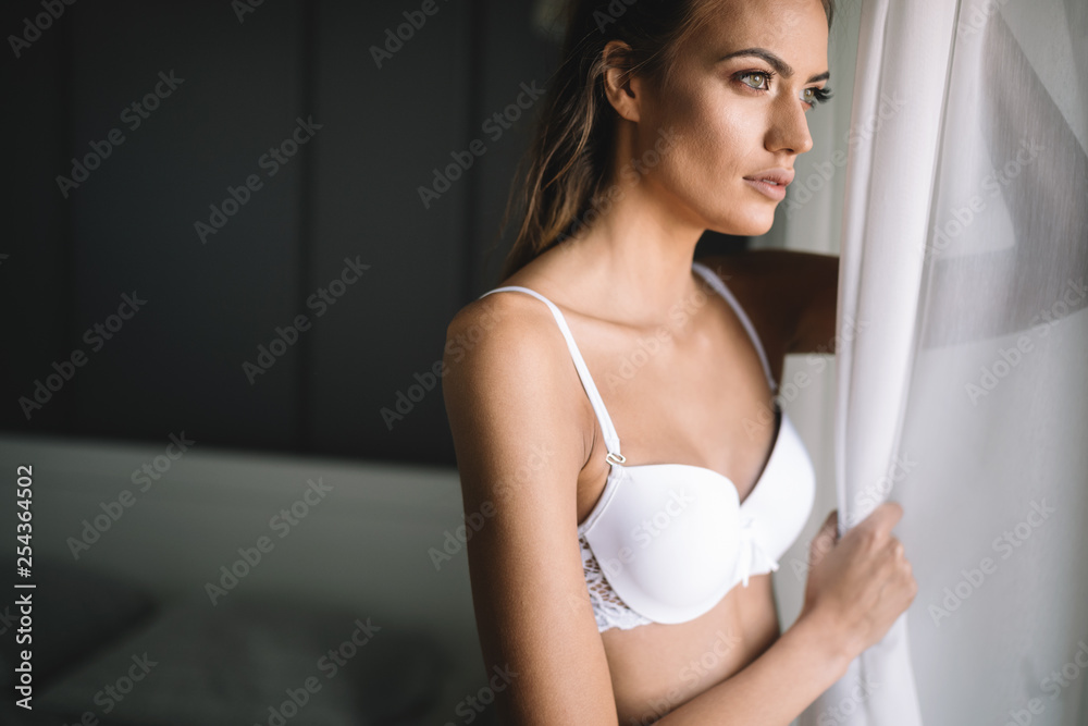 Portrait of beautiful sexy young woman with long hair and glamorous face in lingerie Portrait of beautiful sexy young woman with long hair and glamorous face in lingerie