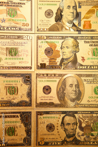 Currency US golden dollar banknotes close-up background.