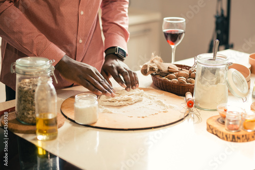 Close up of man kneading dough at home