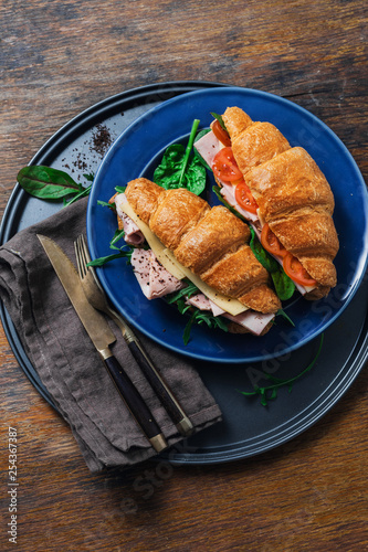 Breakfast croissant sandwiches served plate wooden table photo