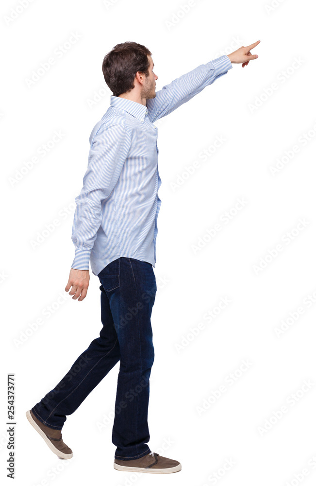 Back view of a man walking with a pointing hand.