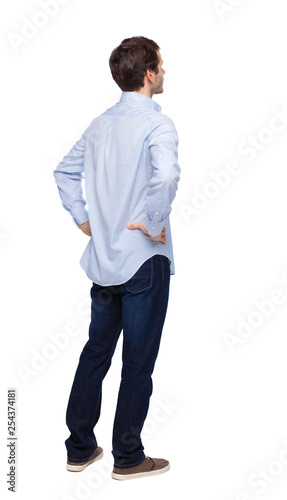 Back view of man in dark jeans. Standing young guy. © ghoststone