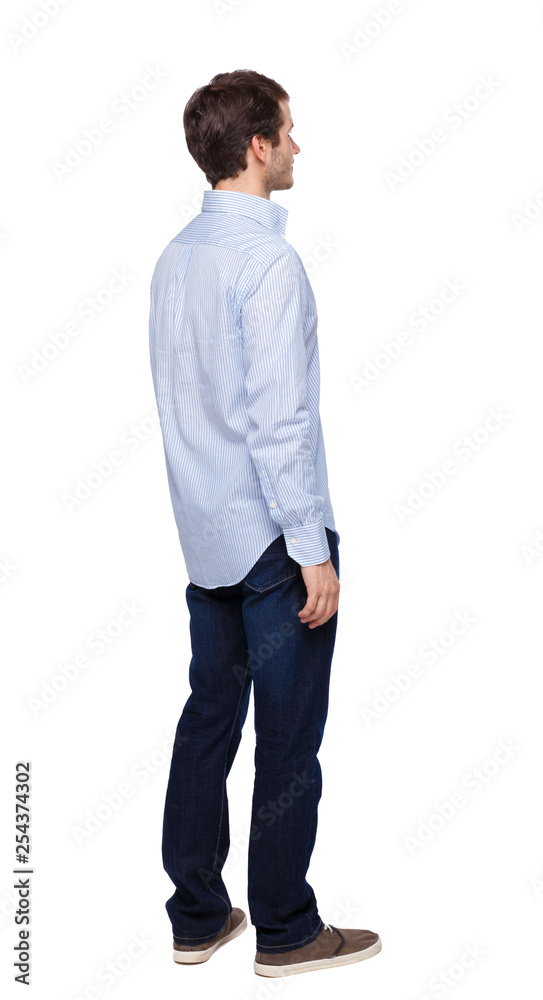 Back view of man in dark jeans. Standing young guy. Back view of man in dark jeans. Standing young guy.