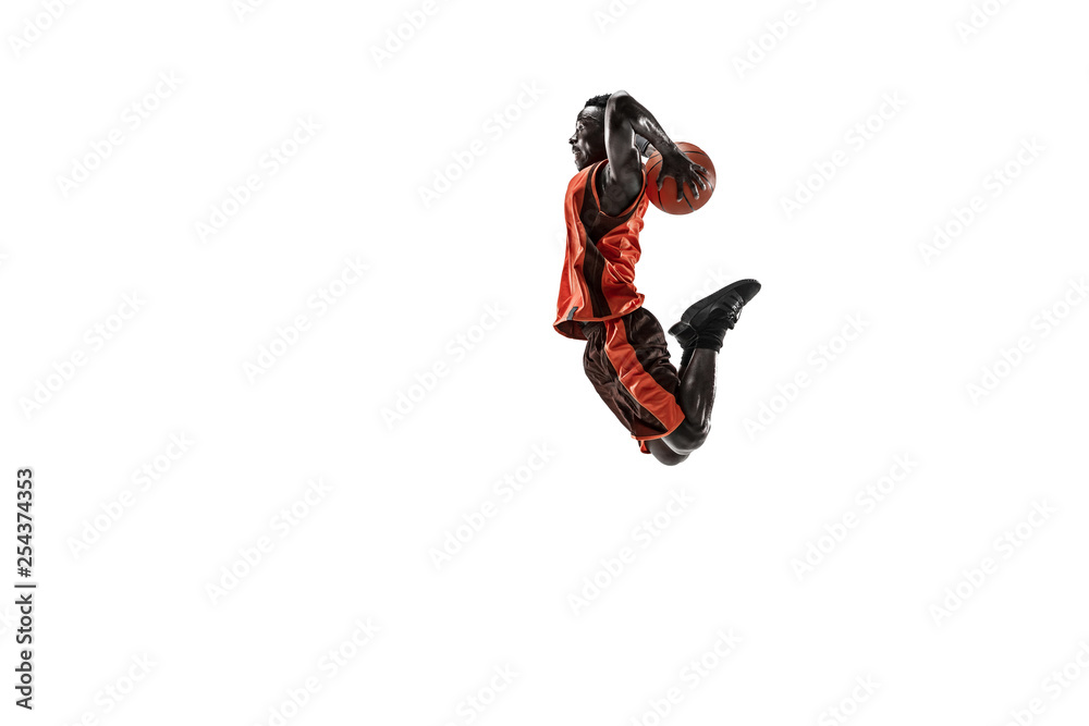 Fototapeta premium Full length portrait of a basketball player with a ball isolated on white studio background. advertising concept. Fit african american athlete jumping with ball. Motion, activity, movement concepts.