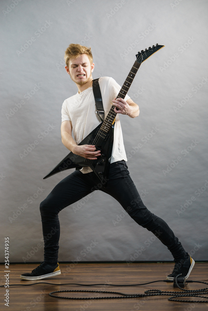 Fototapeta premium Man playing on electric guitar