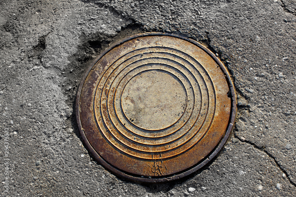 rusty round manhole