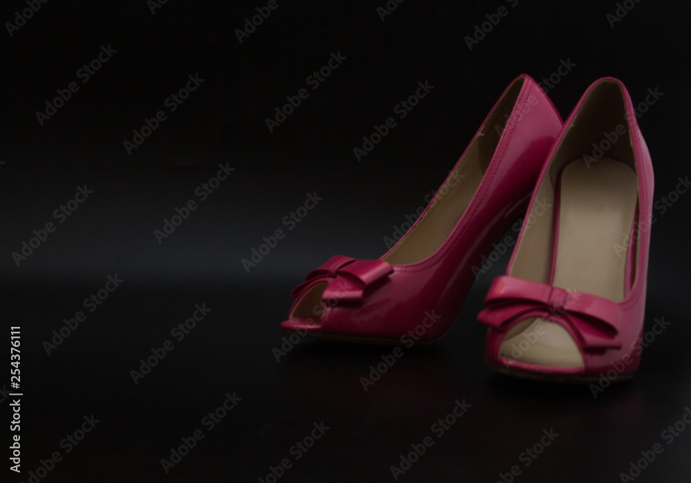 Pink high heels, shoes for women feet, clothes for legs, black background Pink high heels, shoes for women feet, clothes for legs, black background