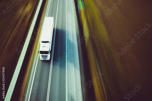 Obraz na plátne Speed white truck - panning by drone