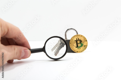 The key to the bitcoin lock is considered a magnifying glass. Concept selection hacking bitcoin.