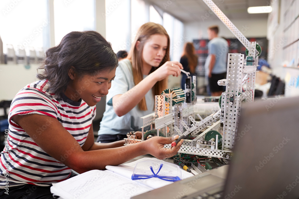 Two Female College Students Building Machine In Science Robotics Or Engineering Class - obrazy, fototapety, plakaty 