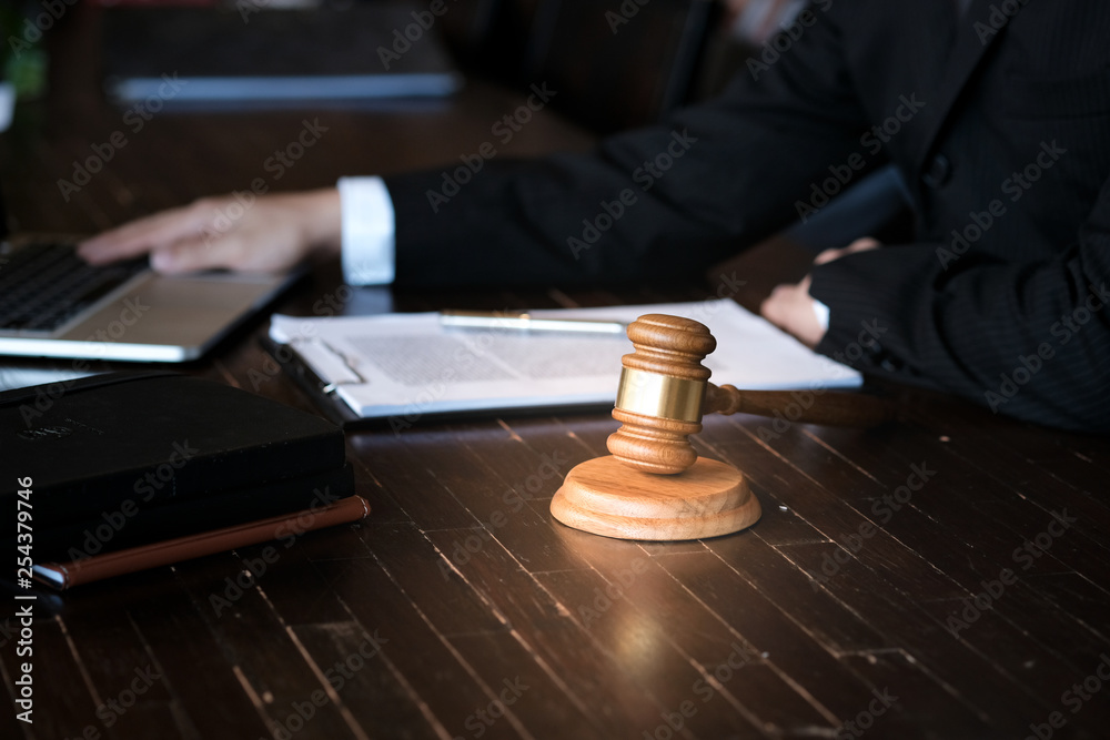 Legal counsel presents to the client a signed contract with gavel and legal law. justice and lawyer concept. Legal counsel presents to the client a signed contract with gavel and legal law. justice and lawyer concept.