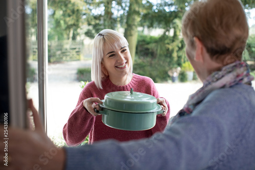 Woman Bringing Meal For Elderly Neighbour