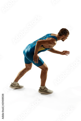 Young caucasian man preparing to run isolated on white studio background. One male runner or jogger. Silhouette of jogging athlete with shadows.