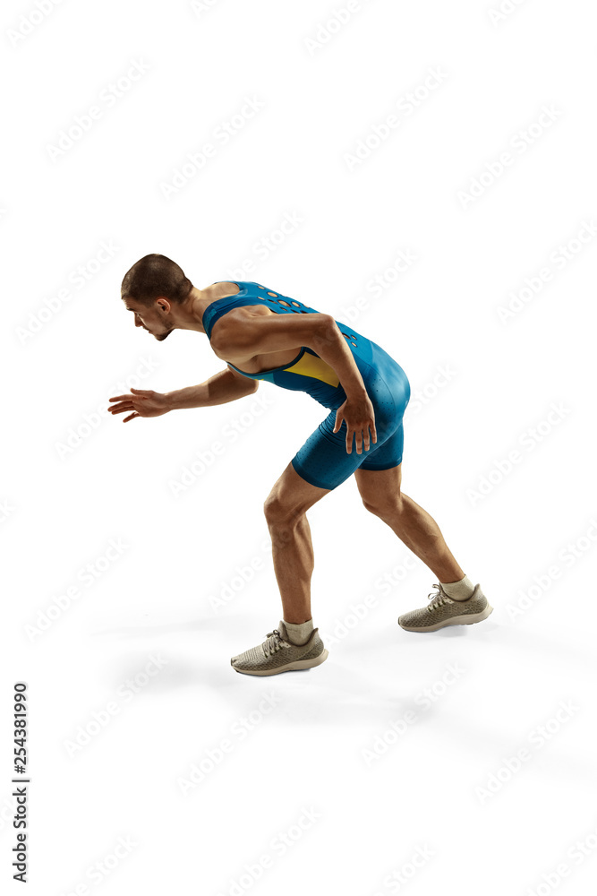 Young caucasian man preparing to run isolated on white studio background. One male runner or jogger. Silhouette of jogging athlete with shadows.