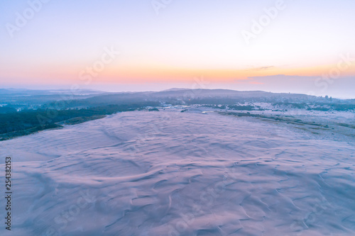 Famous white sand dunes near the ocean at dusk. Anna Bay, New South Wales, Australia