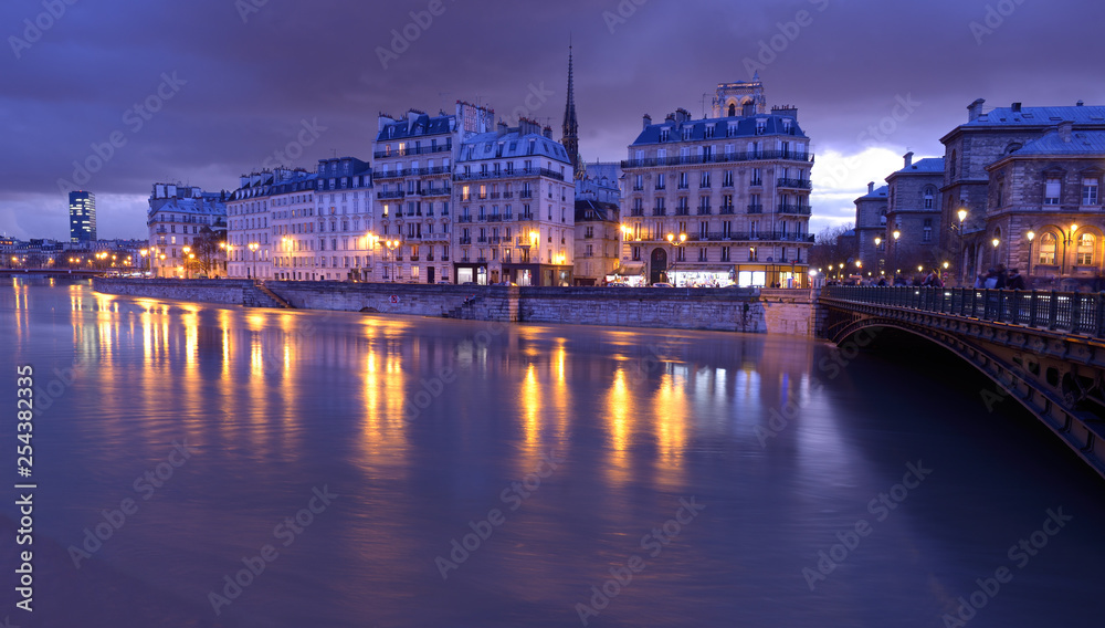 Paris by night.Nocturne view of beautiful Parisian buildings of Ile de la Cite and Seine river. Typical night scenic photo.