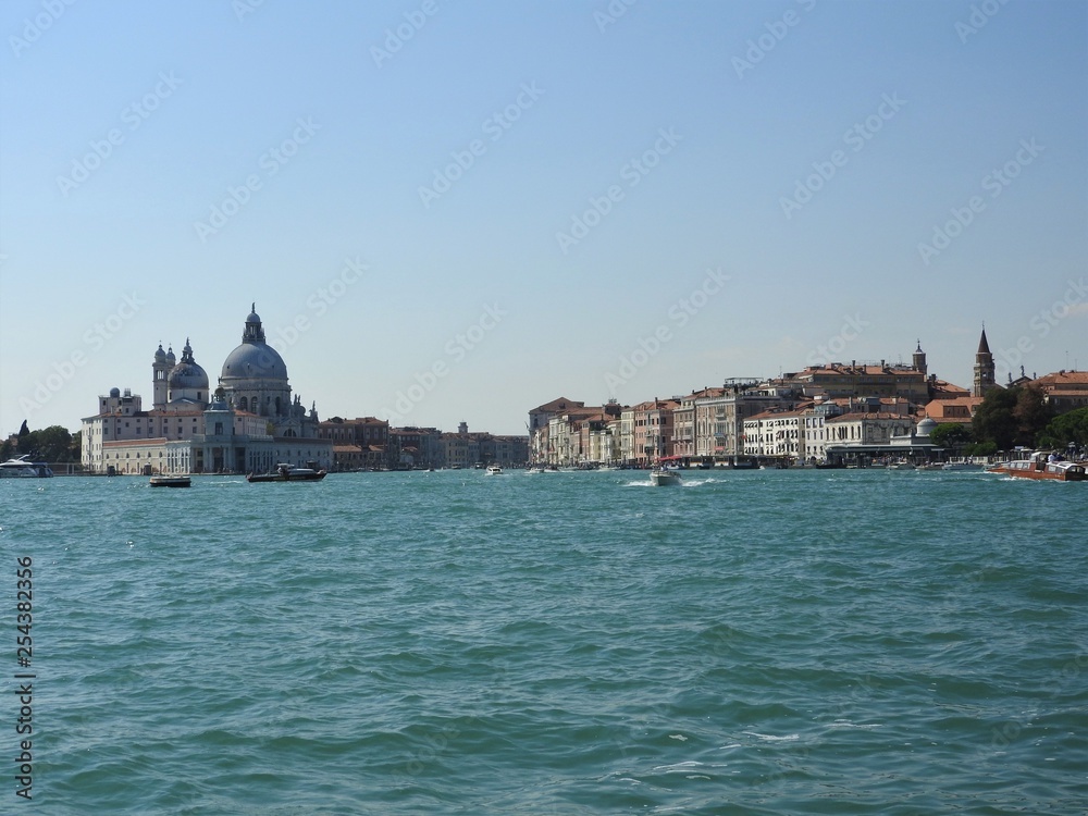 Summer day view from the water to the Venetian lagoon with the Basilica of Santa Maria della Salute in Venice, Italy.