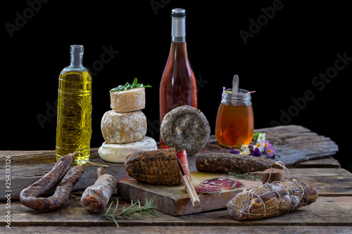 Fototapeta Naklejka Na Ścianę i Meble -  Several variety of traditional Corsican delicatessen and cheese on black background.