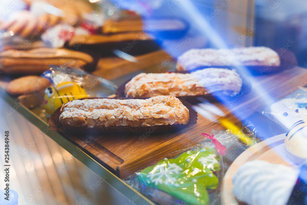 Sweets and eclairs on the counter in the coffee shop Sweets and eclairs on the counter in the coffee shop