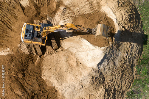 Crawler excavator builds a mound of soil.