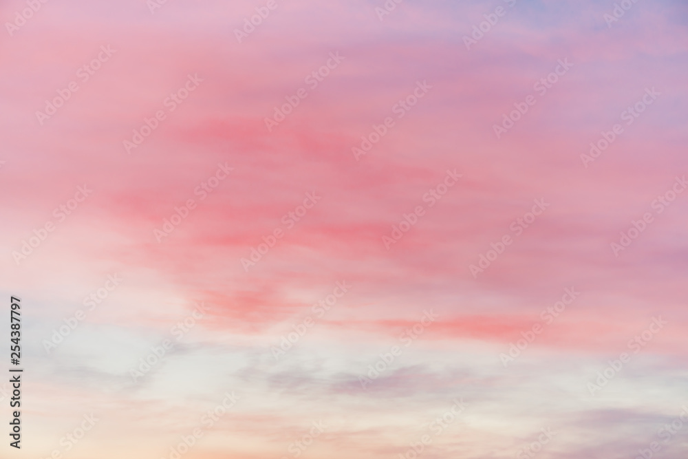 Sunset sky with multicolor light clouds. Colorful smooth sky gradient. Natural background of sunrise. Amazing heaven at morning. Slightly cloudy evening atmosphere. Wonderful weather. Pink dawn clouds