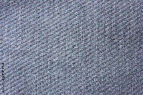 Texture background of seamless plain empty jean fabric. Casual grey denim jeans close up top view of straight material cloth piece. Fashion backdrop for copy space, banner or template