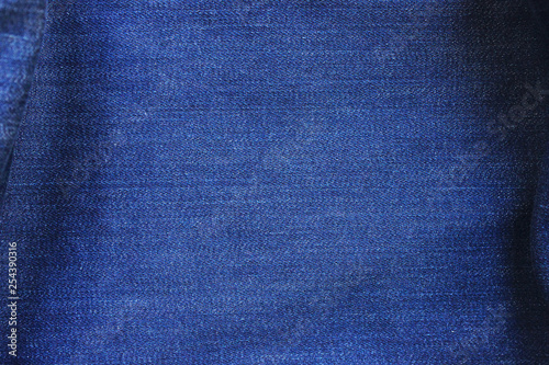 Denim blue jeans texture background of empty worn jean fabric. Close up top view banner and blank backdrop of empty crumpled denim canvas. Modern fashion template of blue color vintage jean canvas