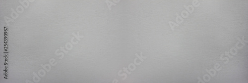 Blank paper texture background of wide bright craft grey notepad page. Pale gray and white seamless pattern of paper, long banner backdrop with empty copy space © onajourney