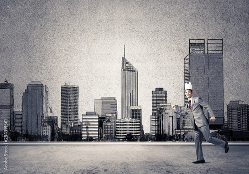 King businessman in elegant suit running and drawn cityscape silhouette at background