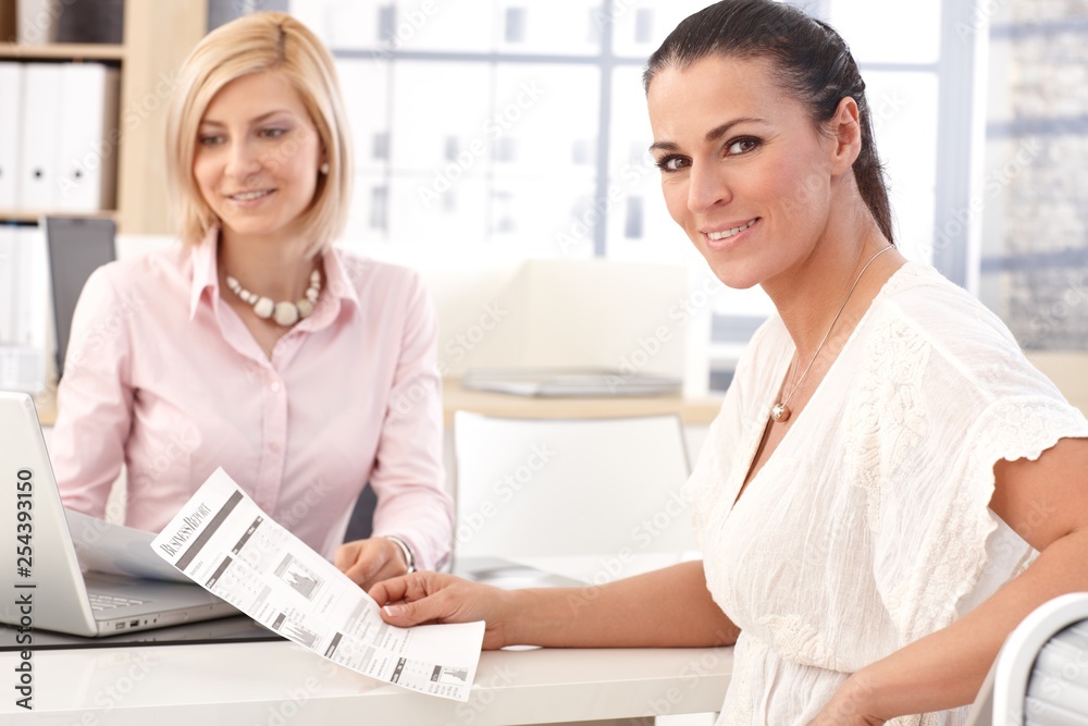 Fototapeta premium Happy businesswoman at office with business report