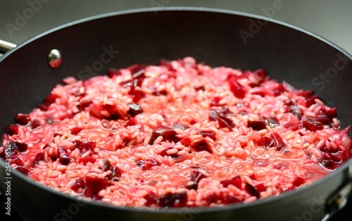 Close-up of a Italian Creamy Beetroot Risotto in the Black Pan. photo