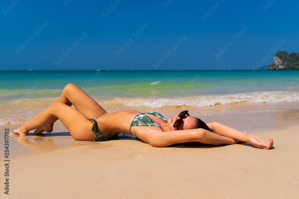 Cute woman relaxing on the summer beach.
